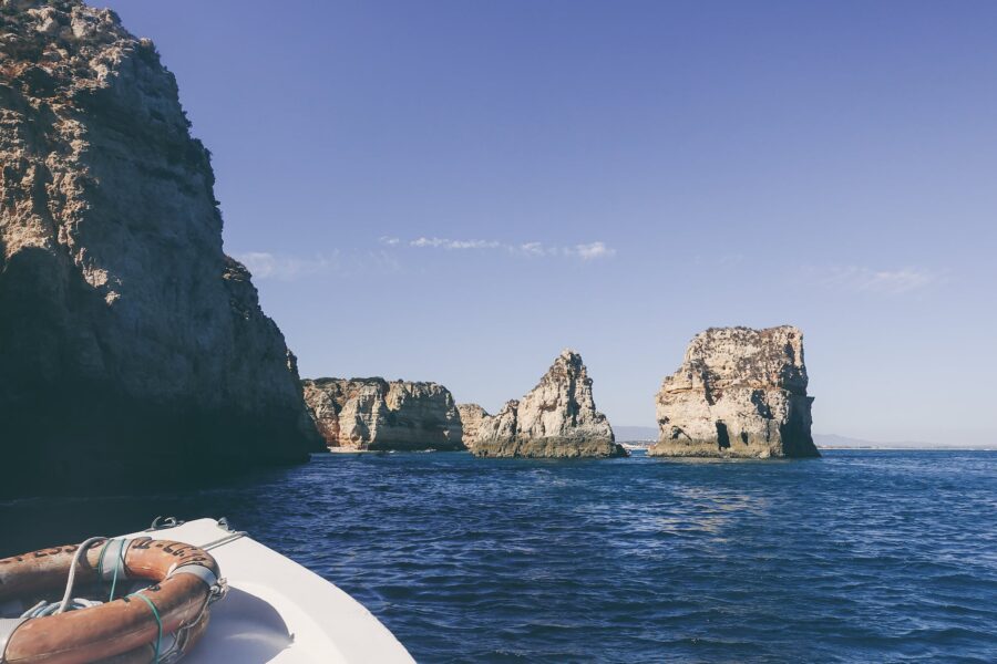 White Boat on Near Cliffs and Rock Formations