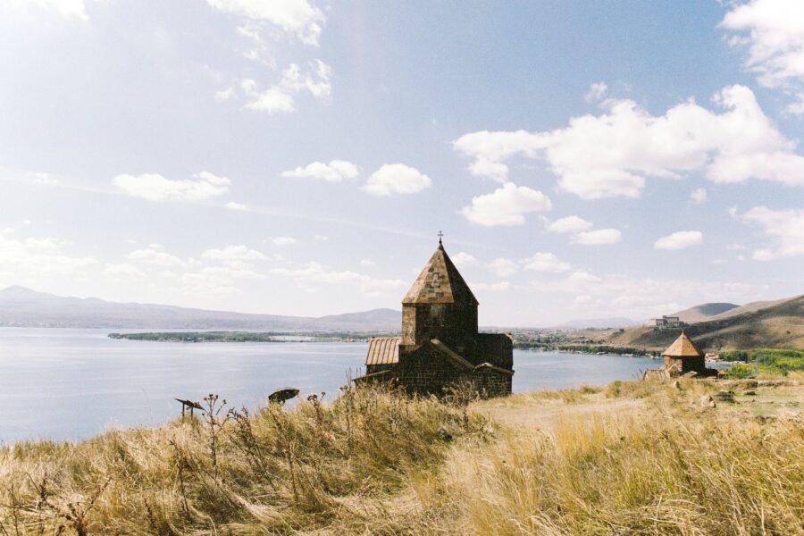 Brown Concrete House Near Body of Water