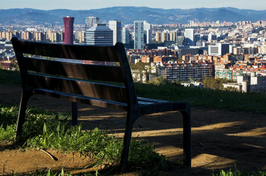 Brown Wooden Bench With Metal Frame Surrounded by Building Scenery