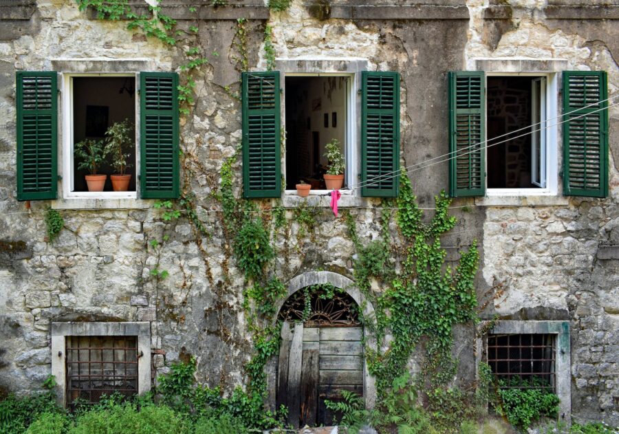 Green Wooden Window Frame on Brown Brick Wall