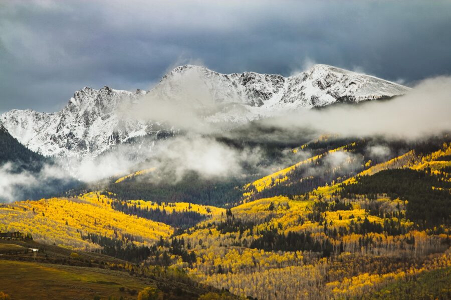 photo of mountains covered with snow and fogs