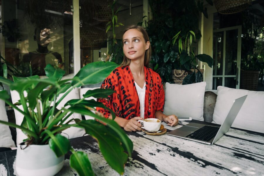 Woman in Red and Black Blazer Holding White Ceramic Cup