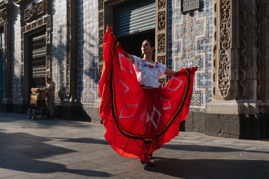 Woman in Traditional Clothing Dancing on Street