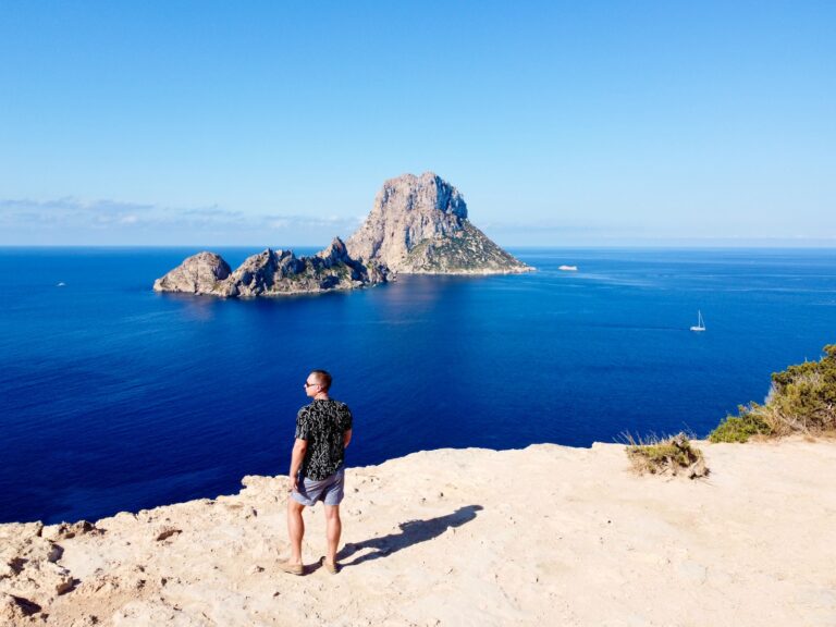 a man standing on a cliff overlooking the ocean