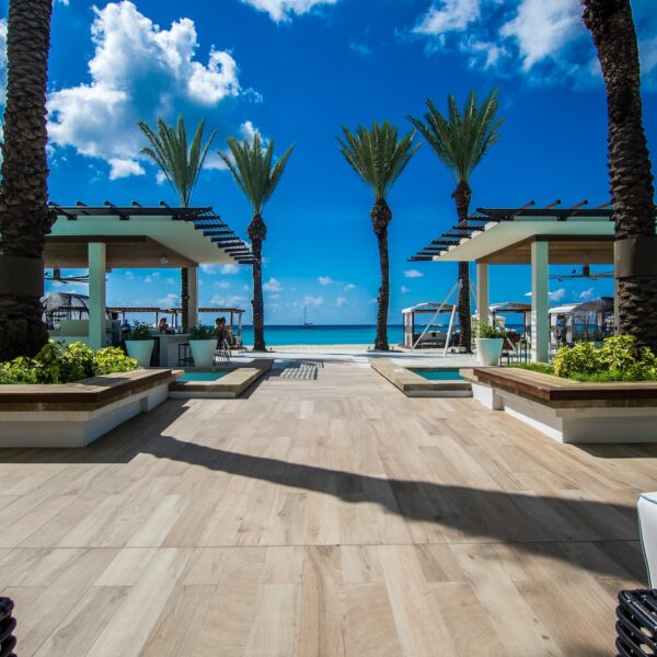 landscape photography of two pergolas near body of water