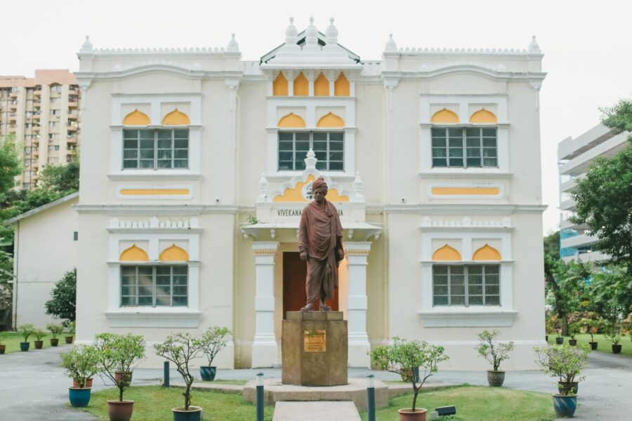 a statue of a man standing in front of a building