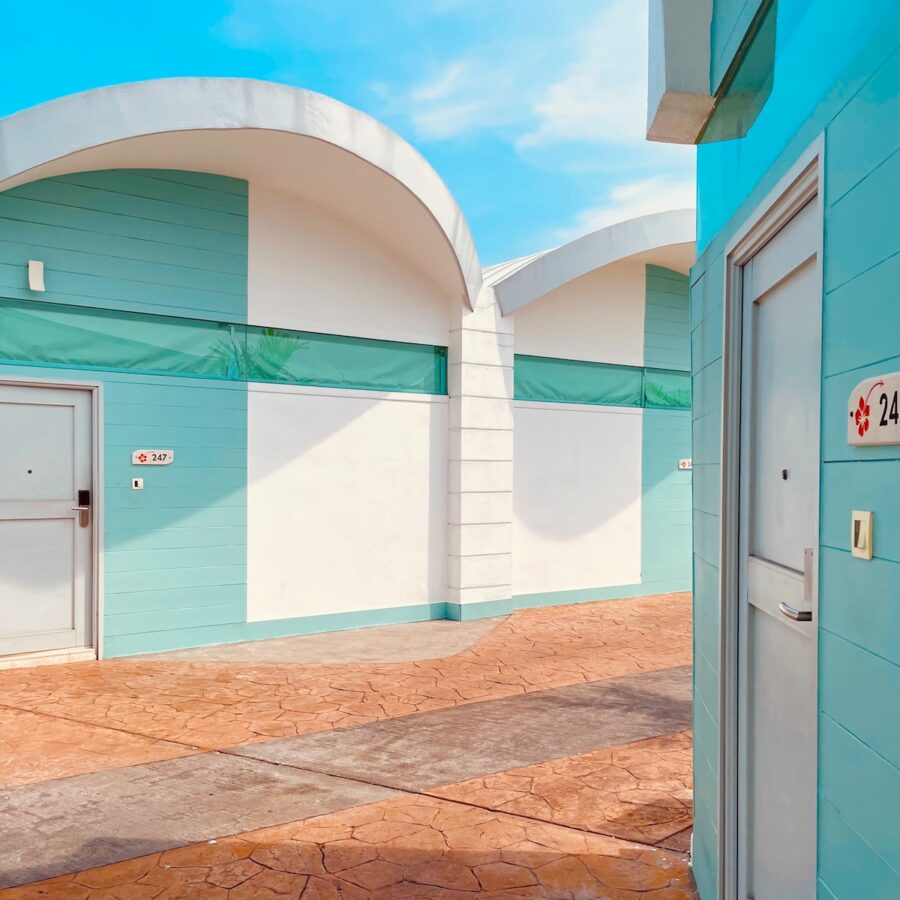 a blue and white building with two white doors