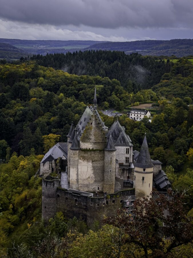 Grey Concrete Castle Surrounded by Green Trees