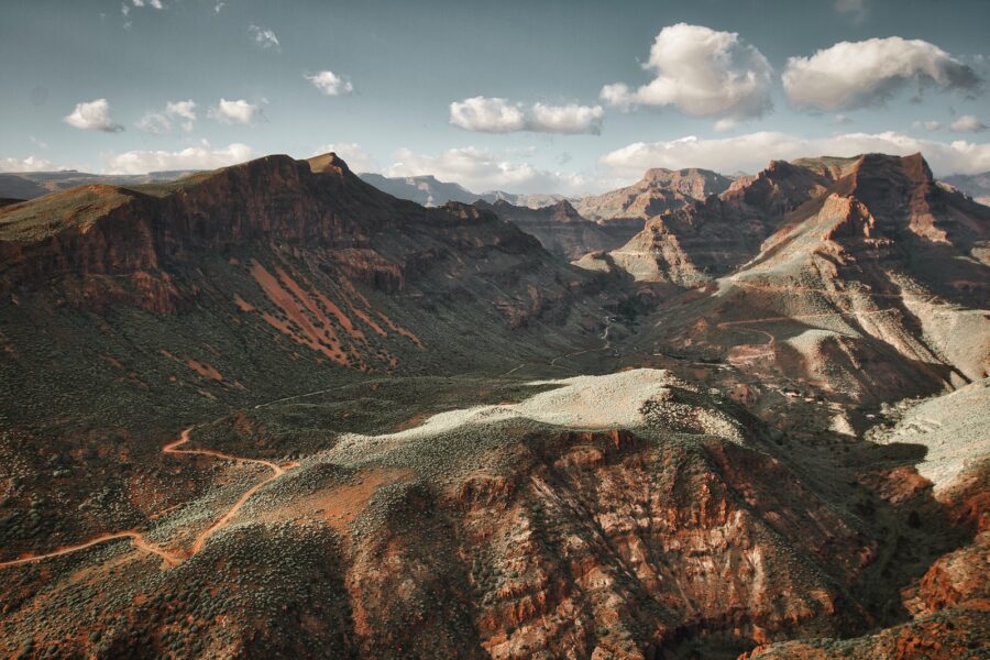 a scenic view of a mountain range with a river running through it