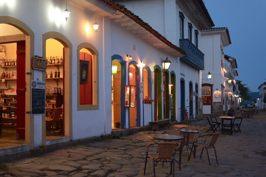 a cobblestone street lined with tables and chairs