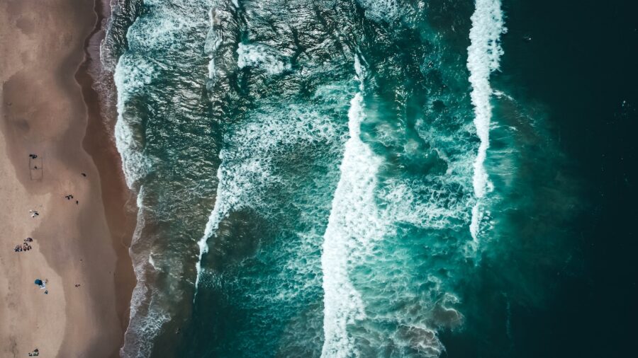 water waves hitting rocks during daytime