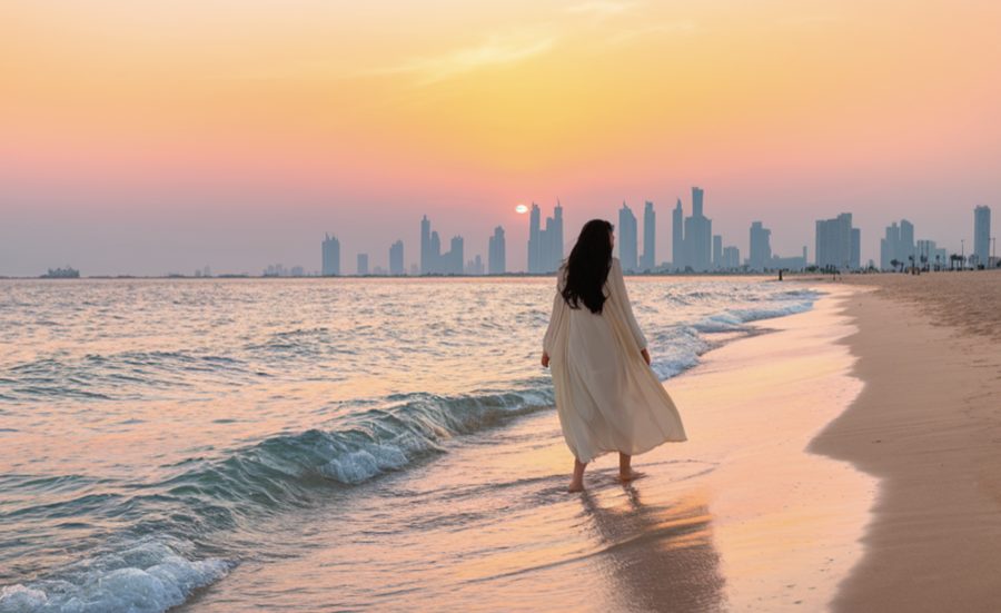 peaceful beach scene at sunset with a person walking along the shoreline